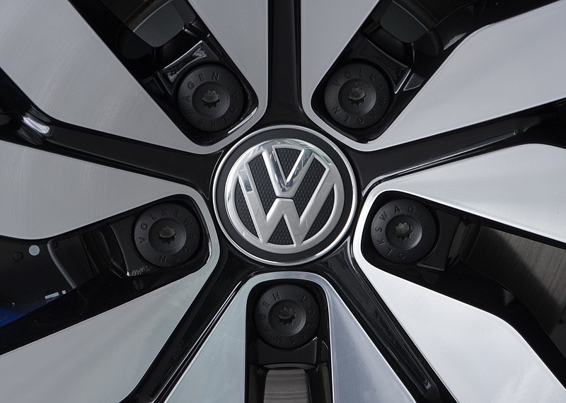 FILE - In this April 28, 2017 file photo an e-Golf electric car with the VW logo on a rim is pictured in the German car manufacturer Volkswagen Transparent Factory (Glaeserne Manufaktur) in Dresden, eastern Germany. (AP Photo/Jens Meyer, file)