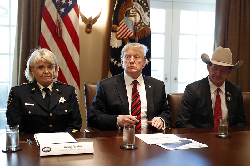 President Donald Trump, with Carolyn "Bunny" Welsh, sheriff of Chester County, Pa., left, and AJ Louderback, sheriff of Jackson County, Texas, attends a roundtable discussion on border security with local leaders, Friday Jan. 11, 2019, in the Cabinet Room of the White House in Washington. (AP Photo/Jacquelyn Martin)

