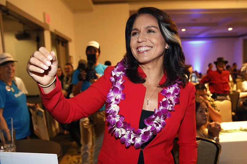 FILE - In this Nov. 6, 2018, file photo, Rep. Tulsi Gabbard, D-Hawaii, greets supporters in Honolulu. Gabbard has announced she's running for president in 2020. The 37-year-old Gabbard said in a CNN interview slated to air Saturday night that she will be formally announcing her candidacy within the week. (AP Photo/Marco Garcia, File)

