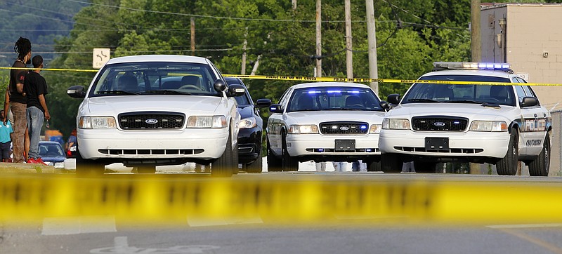 Crime scene tape and police cars are seen along West 38th Street, at the intersection with Central Avenue, as authorities investigate a fatal shooting on Sunday, May 6, 2018 in Chattanooga, Tenn.