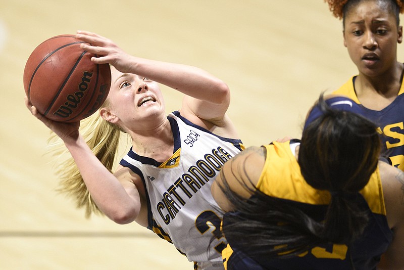 UTC's Lakelyn Bouldin scores on an off-balance shot with two ETSU defenders near her in the Mocs' 76-67 home win Saturday at McKenzie Arena.  
