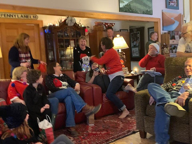 Lancaster family members enjoy a friendly game of Dirty Santa at their annual holiday party. Taking someone's gift during the game can be a friendly, and hysterical, struggle.