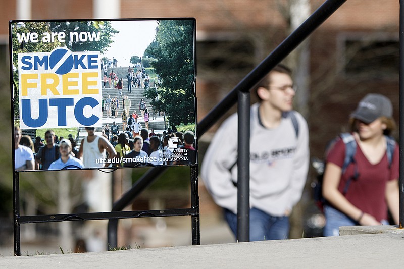 A pair of people walk past a "We Are Now Smoke Free UTC" sign on the campus of the University of Tennessee at Chattanooga on Monday, Jan. 7, 2019 in Chattanooga, Tenn.