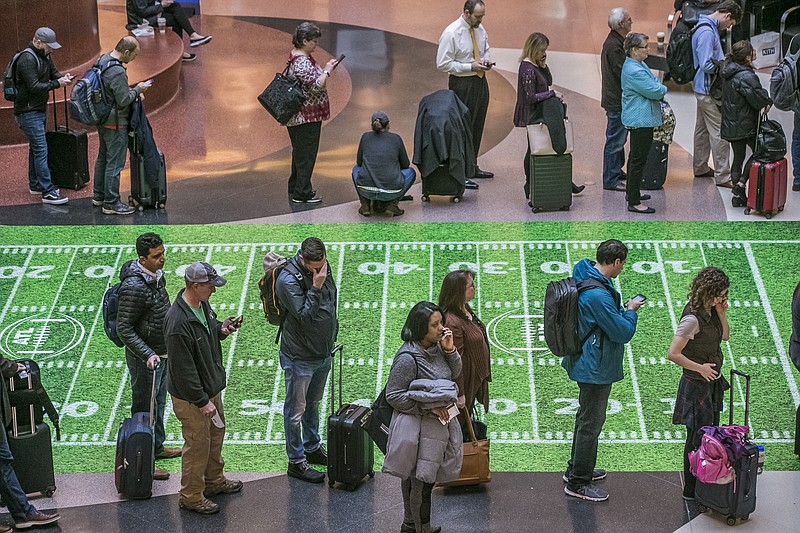 Security lines at Hartsfield-Jackson International Airport in Atlanta stretch more than an hour long amid the partial federal shutdown, causing some travelers to miss flights, Monday morning, Jan. 14, 2019. The long lines signaled staffing shortages at security checkpoints, as TSA officers have been working without pay since the federal shutdown began Dec. 22. (John Spink/Atlanta Journal-Constitution via AP)