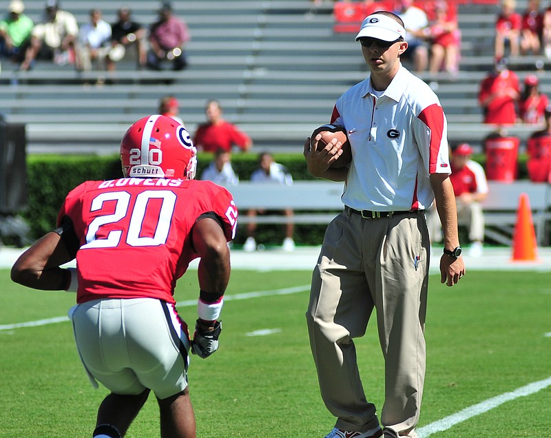 Todd Hartley, shown here as a Georgia graduate assistant working with cornerback Derek Owens during the 2010 season, was announced Monday as the new tight ends coach of the Bulldogs.