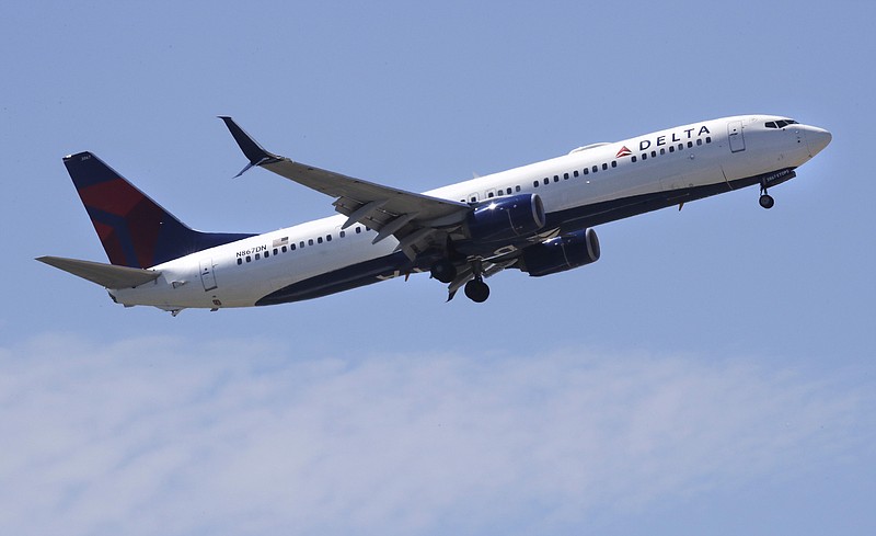 FILE- In this May 24, 2018, file photo a Delta Air Lines passenger jet plane, a Boeing 737-900 model, approaches Logan Airport in Boston. Delta Air Lines, Inc. reports financial results Tuesday, Jan. 15, 2019. (AP Photo/Charles Krupa, File)