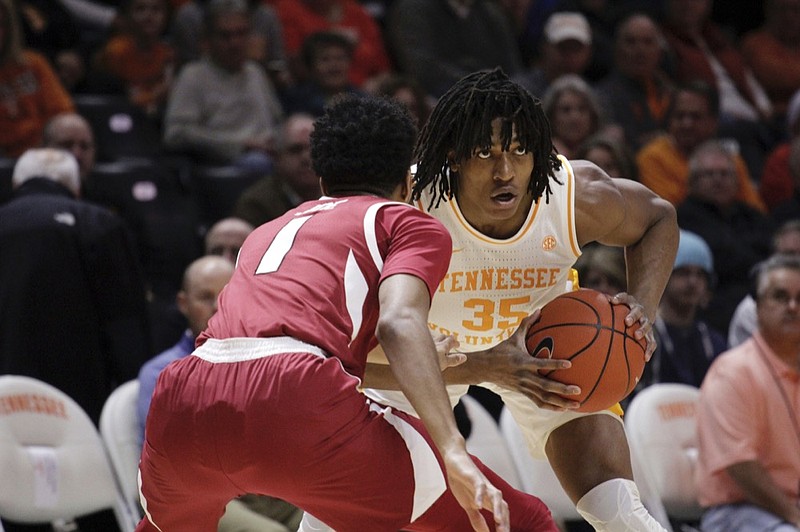 Tennessee forward Yves Pons (35) looks for an open man while Arkansas guard Isaiah Joe (1) defends in the first half of an NCAA college basketball game, Tuesday, Jan. 15, 2019, in Knoxville, Tenn. (AP Photo/Shawn Millsaps)

