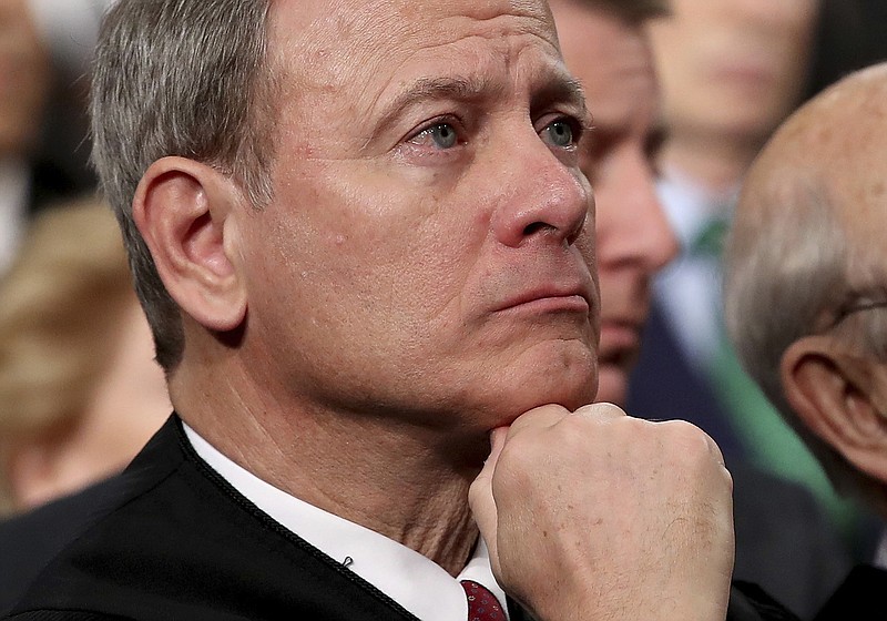 In this Tuesday, Jan. 30, 2018 file photo, U.S. Supreme Court Chief Justice John Roberts listens as President Donald Trump delivers his first State of the Union address in the House chamber of the U.S. Capitol to a joint session of Congress Tuesday in Washington. (Win McNamee/Pool via AP)