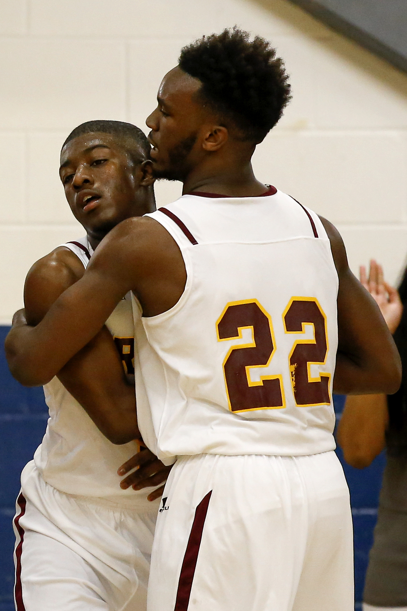 Tyner's Amon Grace (22) hugs teammate Javon Craddock after he was fouled during a Region 3-AA semifinal at Red Bank on Feb. 27, 2018.