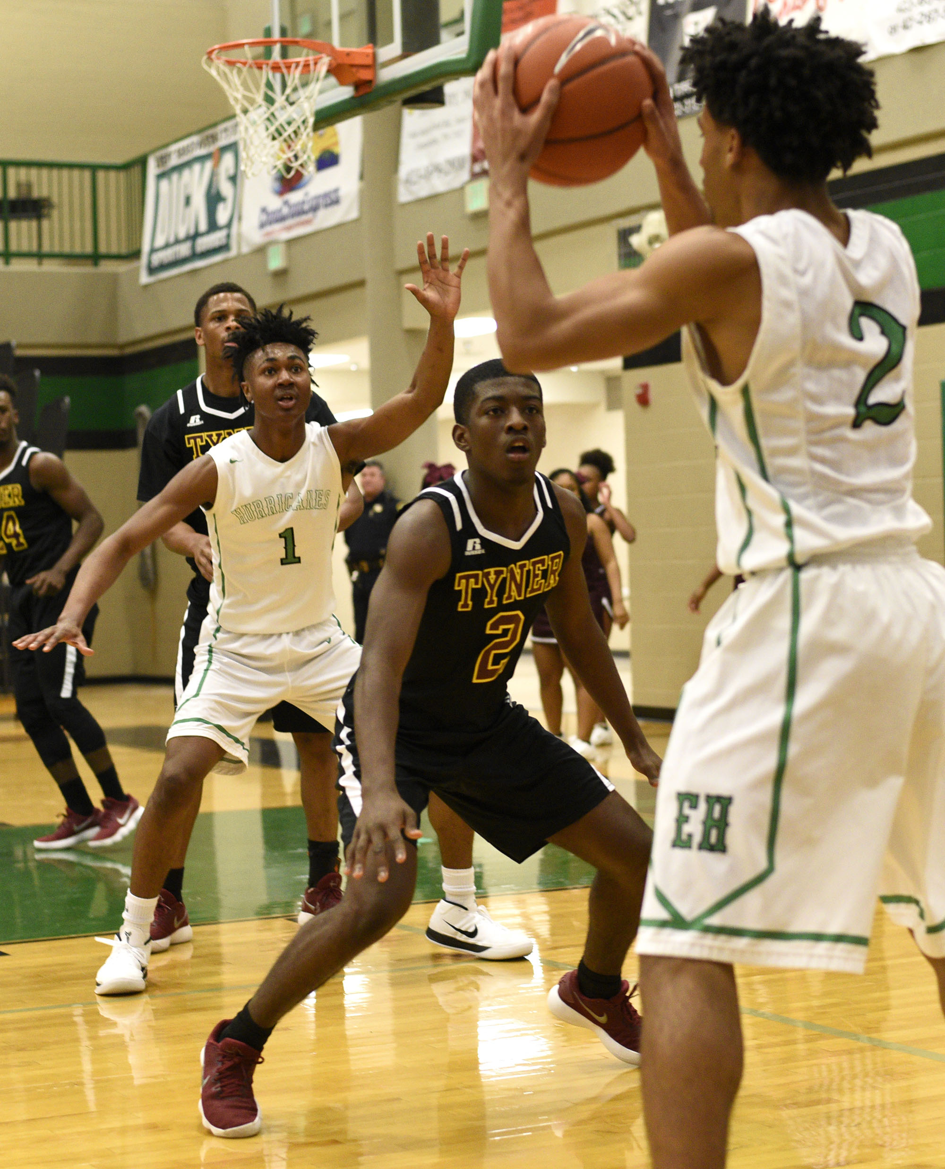 East Hamilton's Andrew Williams (1) calls for the ball from teammate Cameron Montgomery, right, as Tyner's Javon Craddock plays defense during a game on Jan. 19, 2018.