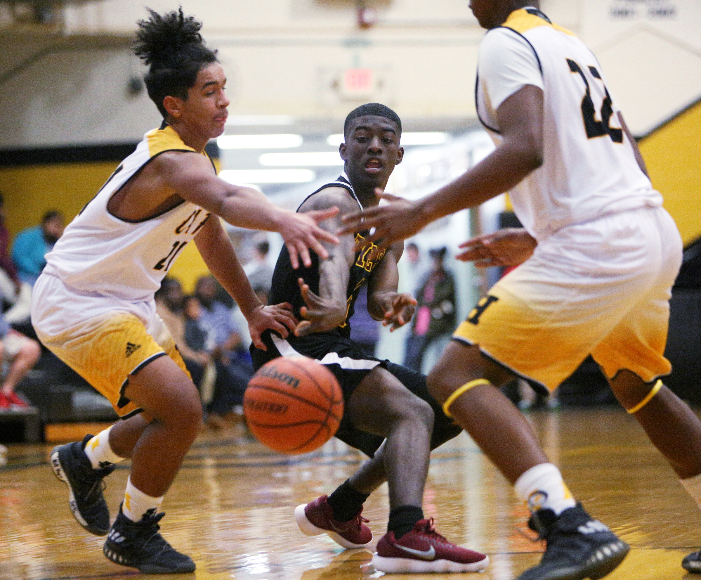 Tyner's Javon Craddock, center, passes to a teammate while being guarded by Hixson's Shawn Long, left, and Terry Moorer during a game on Nov. 28, 2017, at Hixson.