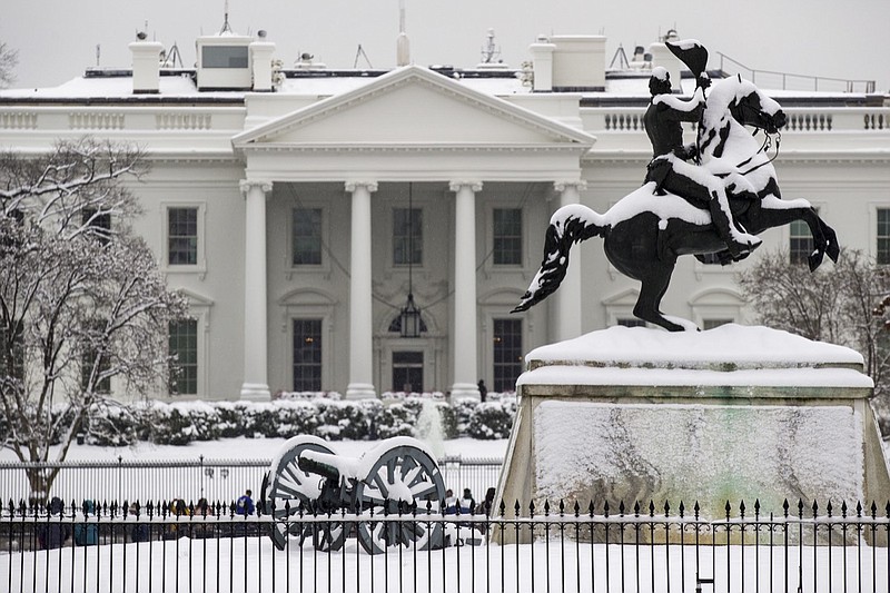 Snow blankets a statue of Andrew Jackson in Lafayette Square with the White House behind, as a winter storm arrives in the region, Sunday, Jan. 13, 2019, in Washington. (AP Photo/Alex Brandon)