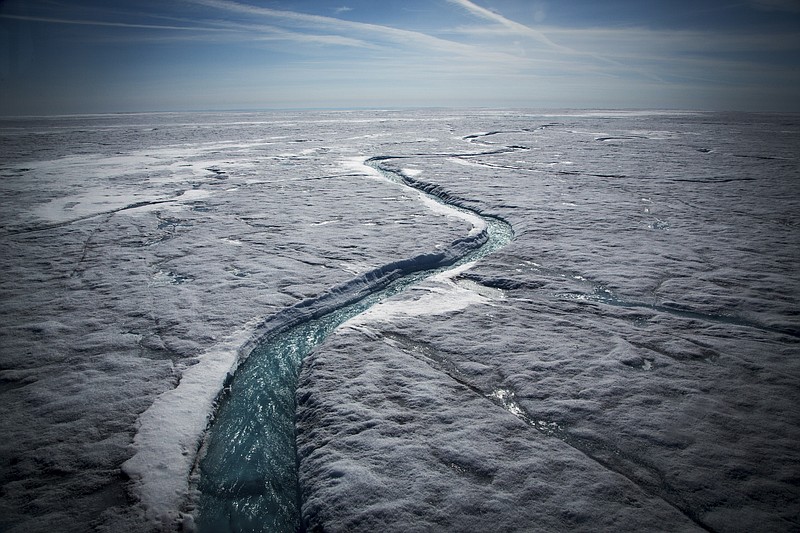 FILE-- Meltwater flows along a supraglacial river on the Greenland ice sheet, one of the biggest and fastest-melting chunks of ice on Earth, on July 19, 2015. Scientists reported Jan. 18, 2017, that the Earth reached its highest temperature on record in 2016. It is the first time in the modern era of global warming data that temperatures have blown past the previous record three years in a row. The heat extremes were especially pervasive in the Arctic. (Josh Haner/The New York Times)