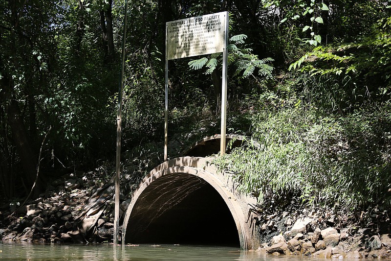 A sign identifying a pipe as a point for treated combined sewer and wastewater sits along Chattanooga Creek Wednesday, August 8, 2018 in Chattanooga, Tennessee. The smell of raw sewage is overwhelming at certain spots along the creek.