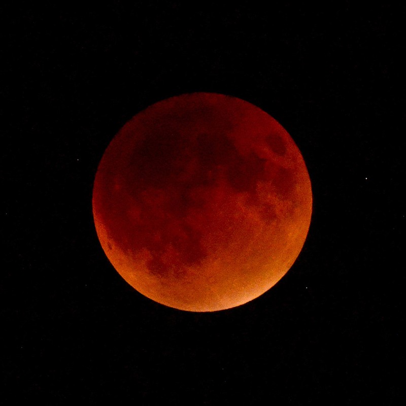 The full moon appears red inside the umbra, or center, of the Earth's shadow at full eclipse during a 2018 lunar eclipse. A total lunar eclipse on Sunday, Jan. 20, 2019, will make the moon appear red.