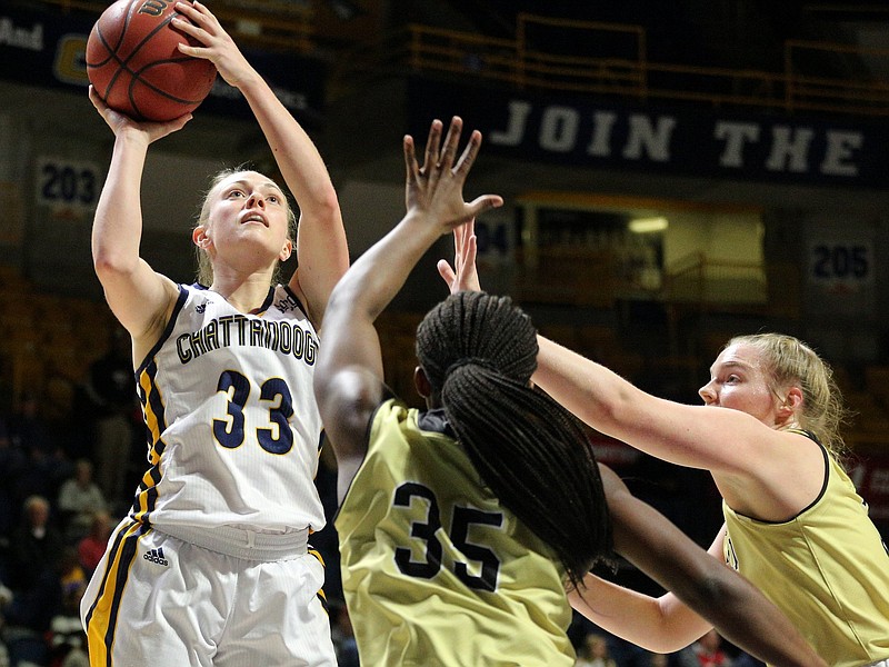 UTC guard Lakelyn Bouldin shoots over Wofford's Da'Ja Green (35) and Marissa Bayer during Thursday's game at McKenzie Arena. Bouldin finished with 26 points, 12 rebounds, five assists and a block as the Mocs beat the Terriers 89-82.