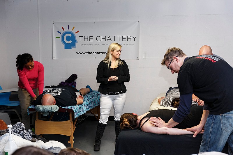 Mattie Bearden, center, owner of Mad Hatter Massage and Wellness in Fort Oglethorpe, Georgia, leads a couples massage class at The Chattery attended by Jennifer Bardoner and her boyfriend Jon Long, right.