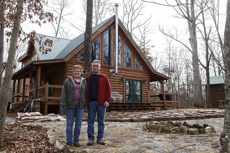 Jane and Bernie Flank pose at their log home paradise near Fall Creek Falls.