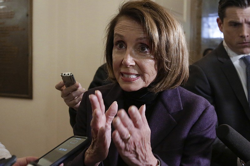 Speaker of the House Nancy Pelosi, D-California, takes questions from reporters as she arrives at the Capitol on Friday. (AP Photo/J. Scott Applewhite)