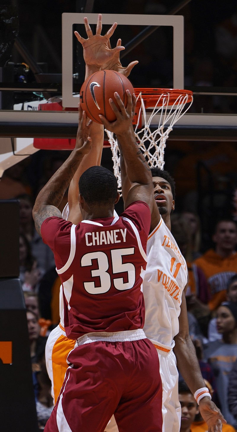 Tennessee's Kyle Alexander attempts to block a shot by Arkansas forward Reggie Chaney during Tuesday night's game in Knoxville. Although Tennessee's lead was never truly threatened, the Razorbacks shot 57 percent from the field in the second half.