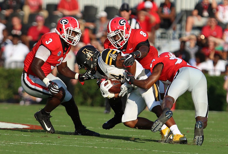 Georgia defensive back Deangelo Gibbs (8) makes a tackle during the Bulldogs' 2017 season opener against Appalachian State in Athens, Ga.
