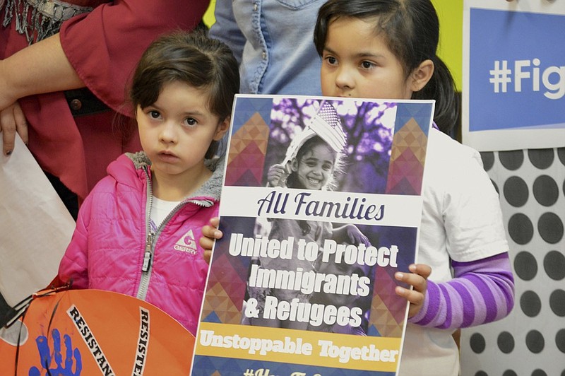 FILE - In this Jan. 25, 2017 file photo, Jocelynn Lujan, left, and her sister, Jennifer, attend a news conference in Albuquerque, N.M., where activists denounced President Donald Trump's executive actions on immigration. Identical Democratic proposals in the New Mexico House and Senate would prevent state agencies from cooperating with federal immigration authorities and limit the authority of sheriffs and jails to hold federal immigrant detainees. (AP Photo/Russell Contreras, File)


