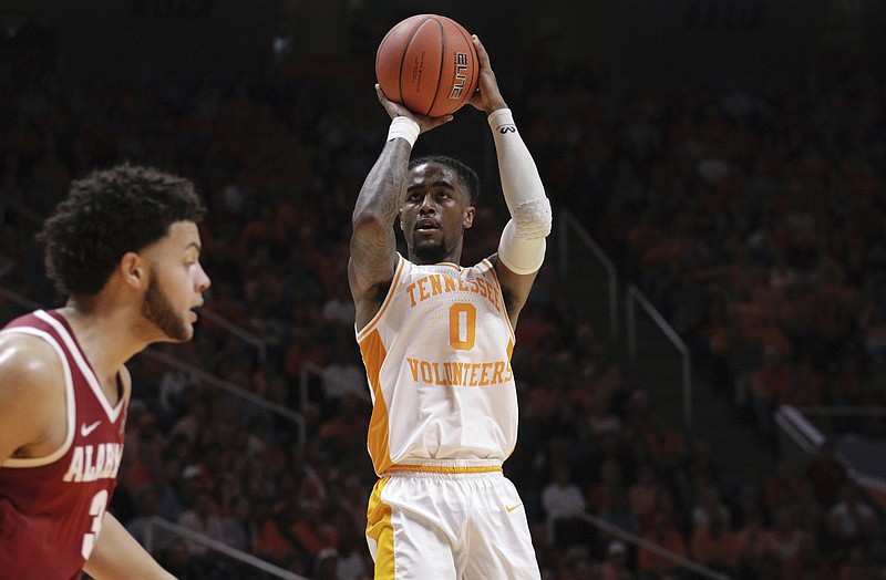 Tennessee guard Jordan Bone releases a shot over Alabama's defense in the second half of Saturday's game in Knoxville. Tennessee won 71-68.