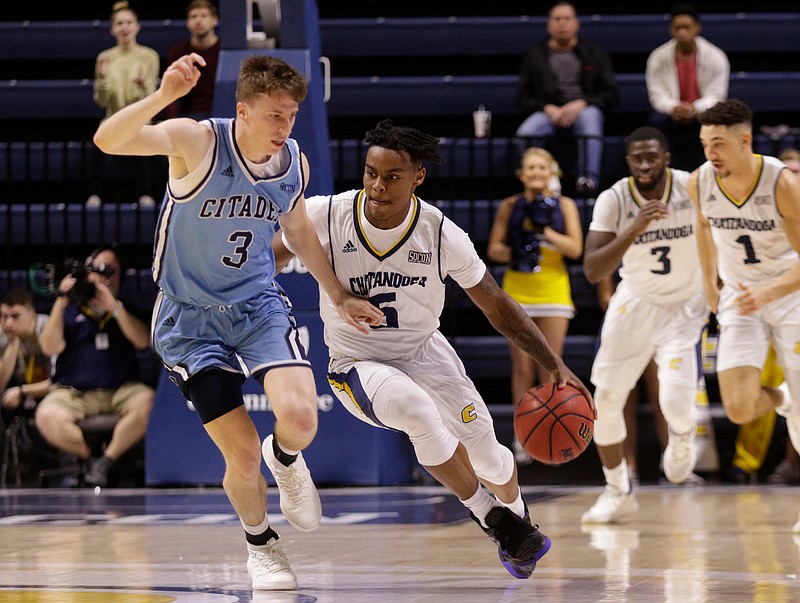 UTC's Donovann Toatley dribbles around The Citadel's Matt Frierson during Saturday's game at McKenzie Arena.