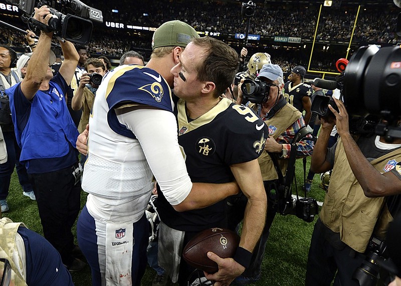 Quarterbacks Jared Goff of the Los Angeles Rams, left, and Drew Brees of the New Orleans Saints, right, greet each other after their teams played a regular-season game Nov. 4, 2018, in New Orleans. The Saints won 45-35, and today they face the Rams again with the NFC title and a spot in the Super Bowl on the line.