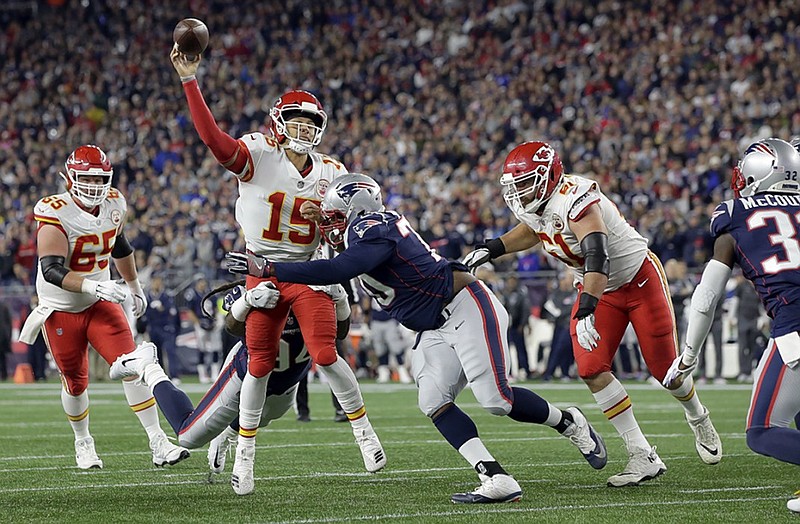 Kansas City Chiefs quarterback Patrick Mahomes passes under pressure from New England Patriots defensive tackle Adam Butler during the teams' regular-season meeting on Oct. 14, 2018, in Foxborough, Mass. The Patriots won 43-40, but today they must visit the Chiefs with the AFC title and a spot in the Super Bowl on the line.