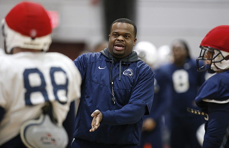 Charles Huff talks to players during the Penn State football team's practice ahead of the Pinstripe Bowl in December 2014. Huff was the Nittany Lions' special-teams coordinator and running backs coach from 2014 to 2017, and he was Mississippi State's running backs coach this past season, but according to multiple media reports Sunday, he will be hired for the same role at Alabama.