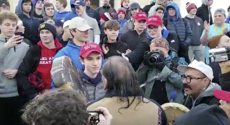 Nick Sandmann, in red hat, and his fellow Covington Catholic School students were accused of taunting Native American Nathan Phillips on Friday in Washington, D.C., but the real story that Phillips and other activists had approached the students (and all that ensued) emerged over the weekend.