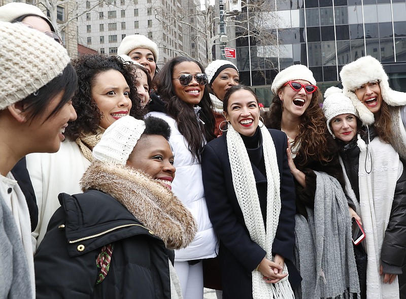 U.S. Rep. Alexandria Ocasio-Cortez, center, with white scarf, poses for a photograph with members of the Womens Resistance Revival Chorus before speaking at the Women's March NYC rally at Foley Square in Lower Manhattan last Saturday in New York. (AP Photo/Kathy Willens)