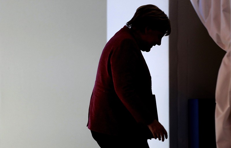 German Chancellor Angela Merkel exits the stag after addressing the annual meeting of the World Economic Forum in Davos, Switzerland, Wednesday, Jan. 23, 2019. (AP Photo/Markus Schreiber)