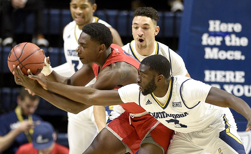 Samford's Brandon Austin, rear, keeps the ball from UTC's David Jean-Baptiste during their SoCon matchup Jan. 12 at McKenzie Arena. The Mocs won 80-75 and have also won both of their games since, topping SoCon foes Mercer, 73-70 on Jan. 17, and The Citadel, 73-71 last Saturday.