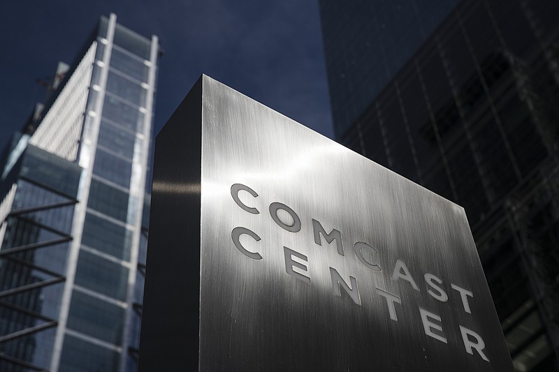 FILE- This May 21, 2018, file photo shows a sign outside the Comcast Center in Philadelphia. Comcast Corp. reports financial results Wednesday, Jan. 23, 2019. (AP Photo/Matt Rourke, File)