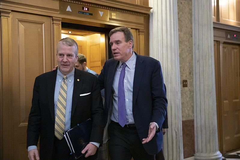 Sen. Mark Warner, D-Virginia, vice-chairman of the Senate Intelligence Committee, at right, on Wednesday introduced the Stop STUPIDITY Act, which is aimed to prevent future government shutdowns in the event of funding lapses. At left is Sen. Dan Sullivan, R-Alaska. (AP Photo/J. Scott Applewhite)