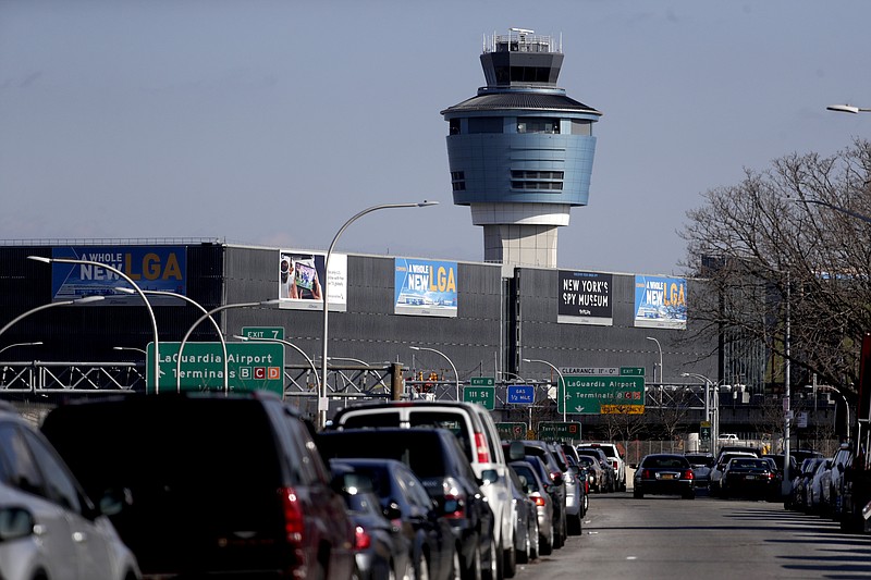 The air traffic control tower at LaGuardia Airport is seen, Friday, Jan. 25, 2019, in New York. The Federal Aviation Administration reported delays in air travel Friday because of a "slight increase in sick leave" at two East Coast air traffic control facilities.  (AP Photo/Julio Cortez)