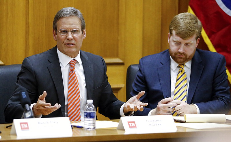 Tennessee Gov. Bill Lee, left, leads his first cabinet meeting, Tuesday, Jan. 22, 2019, in Nashville, Tenn. At right is Blake Harris, his chief of staff. (AP Photo/Mark Humphrey)