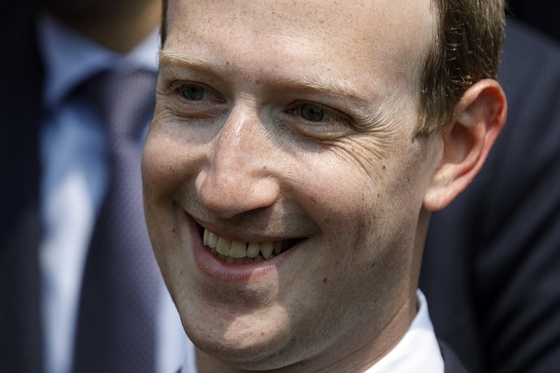 FILE - In this May 23, 2018 file phpoto, Facebook's CEO Mark Zuckerberg smiles during a picture with guests attending the "Tech for Good" Summit at the Elysee Palace in Paris. Zuckerberg's latest attempt to explain Facebook's data-sharing practices is notable for its omissions as well as what it plays up and plays down. In a Wall Street Journal op-ed Thursday, Jan. 24, 2019, titled "The Facts About Facebook," the CEO doubles down on previous talking points while leaving out, for example, a Federal Trade Commission investigation over its privacy practices. (Charles Platiau/Pool Photo via AP, File)

