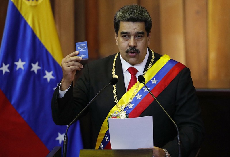 In this Jan. 10, 2019, file photo, Venezuela's President Nicolas Maduro holds up a small copy of the constitution as he speaks during his swearing-in ceremony at the Supreme Court in Caracas, Venezuela. The coalition of Latin American governments that joined the U.S. in quickly recognizing opposition leader Juan Guaido as Venezuela's interim president, and not Maduro, came together during weeks of secret diplomacy. (AP Photo/Ariana Cubillos, File)