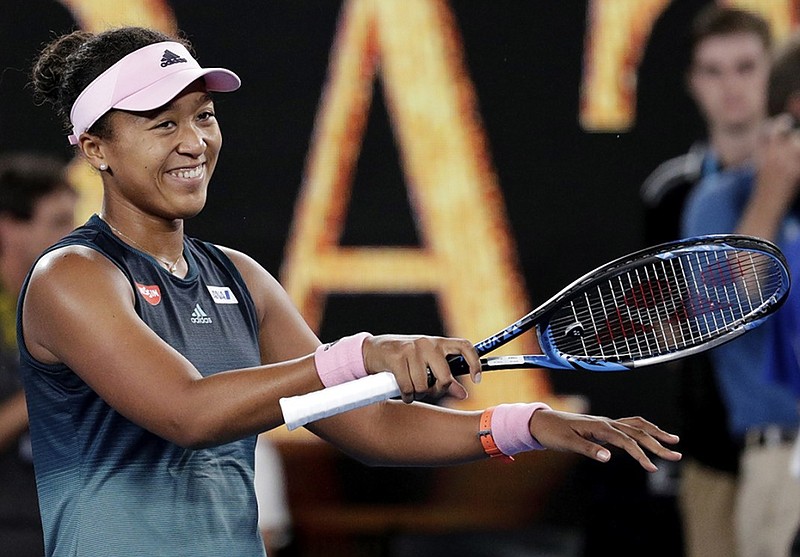 Naomi Osaka celebrates after defeating Petra Kvitova in the Australian Open women's singles final Saturday night in Melbourne. Osaka has won two straight major championships, having beaten Serena Williams to win the U.S. Open last September in New York.