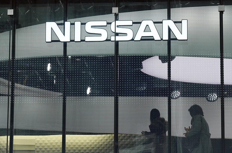 FILE - In this Nov. 22, 2018, file photo, visitors walk near the logo of Nissan at a Nissan showroom in Tokyo. Nissan Motor Co. says it has received an inquiry from the U.S. Securities and Exchange Commission. The Japanese automaker said in a statement Monday, Jan. 28, 2019, that it "can confirm that we have received an inquiry from the SEC, and are cooperating fully. We cannot provide further details." (AP Photo/Eugene Hoshiko, File)