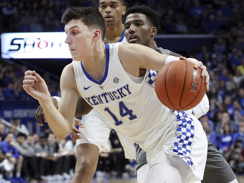 Kentucky's Tyler Herro (14) drives near Mississippi State's Nick Weatherspoon during the first half of an NCAA college basketball game against in Lexington, Ky., Tuesday, Jan. 22, 2019. (AP Photo/James Crisp)

