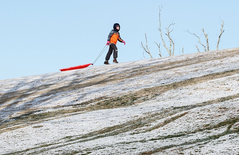 Staff photo by Doug Strickland / 
Carter Alley carries his sled to the top of a hill while sledding at Signal Mountain Golf and Country Club on Tuesday, Jan. 29, 2019, in Signal Mountain, Tenn. Predicted snowfall missed Chattanooga but accumulated in higher elevations and the surrounding region.