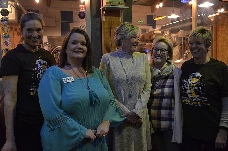 Board members from the Sexual Assault Center stand together during their co-hosted Abolish Human Trafficking event at Pie Slingers Pizzeria. From left are Jennifer McSpadden, creator of "Blonde Abolitionist"; Rachel Robinson, Vicki Scoggins, Cindie Patty and Lecia Guthrie. (Staff photo by Myron Madden)