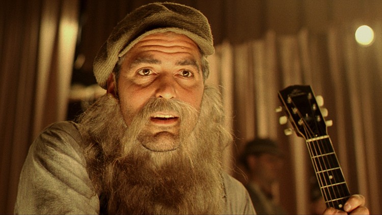 George Clooney, as Ulysses Everett McGill, dons a fake beard to sing with The Soggy Bottom Boys in "O Brother, Where Art Thou." / Universal Pictures photo
