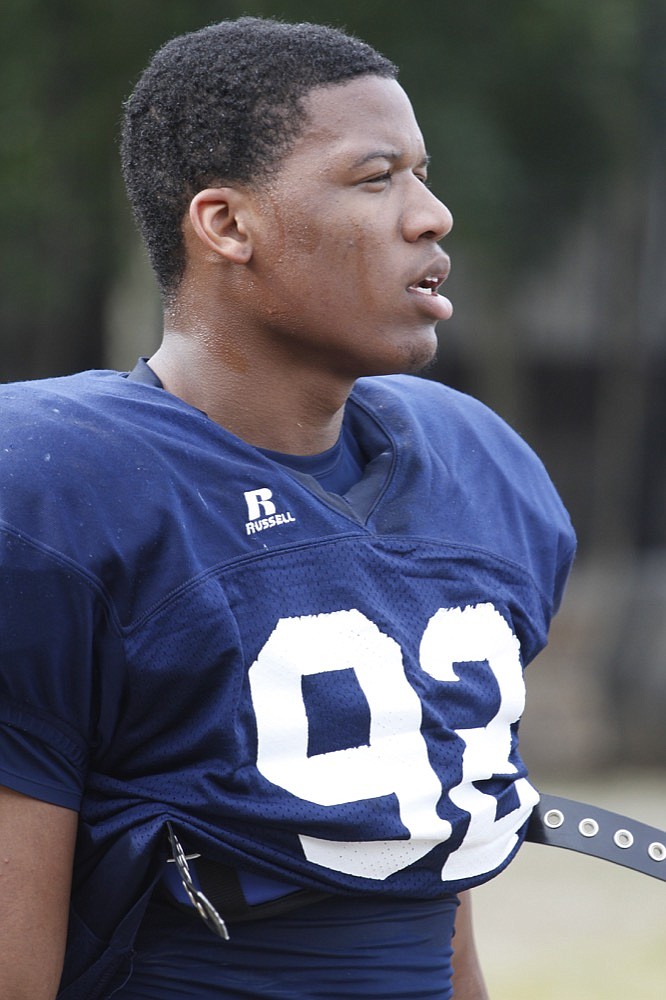 Staff Photo by Dan Henry / The Chattanooga Times Free Press- 3/21/14. UTC defensive lineman Keionta Davis (#93 - wearing #92) performs drills during the Moc's first practice in pads at Scrappy Moore Field on March 21, 2014. 