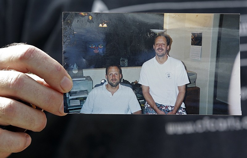 In this Oct. 2, 2017 file photo, Eric Paddock holds a photo of himself, at left, and his brother, Stephen Paddock, at right, outside his home in Orlando, Fla. The FBI has concluded its investigation into the deadliest mass shooting in modern U.S. history without determining a motive. The FBI makes the conclusion in a report given to The Associated Press on Tuesday, Jan. 29, 2019. After nearly 16 months, the agency says it can't determine why gunman Stephen Paddock killed 58 people and injured nearly 900 others in October 2017. (AP Photo/John Raoux, File)