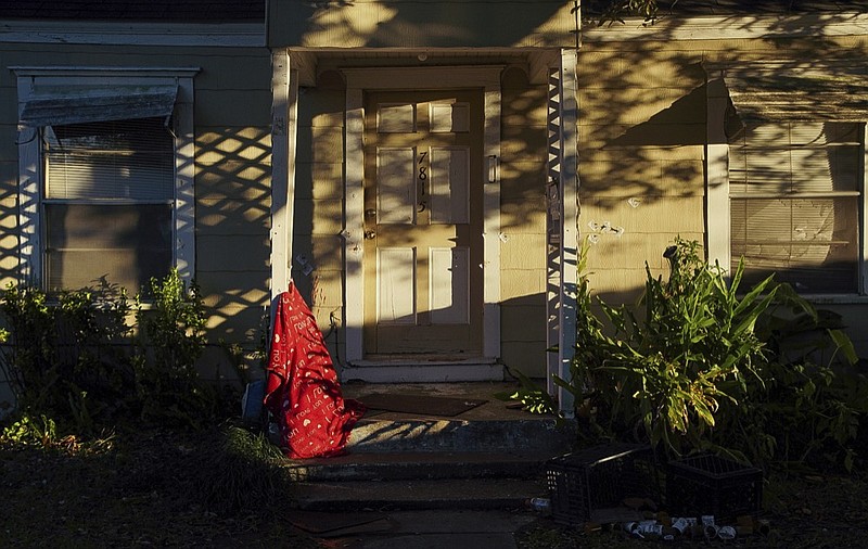 Bullet holes can be seen on the front entrance of a home, where five Houston Police officers were shot while serving a warrant Tuesday, Jan. 29, 2019, in Houston. An attempt to serve a search warrant at a suspected drug house on Monday, quickly turned into a gunbattle that killed two suspects and injured five undercover narcotics officers, including four who were shot, Chief Art Acevedo said. Rhogena Nicholas was shot and killed as she tried to grab the service weapon of the first officer to be injured, Acevedo said. The second suspect killed was 59-year-old Dennis Tuttle. (Godofredo A. Vasquez/Houston Chronicle via AP)/Houston Chronicle via AP)

